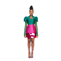 A model wearing a green Abeke top and a Magenta Abeke skirt embellished with sequins