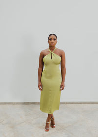 A model wearing an olive halter neck dress