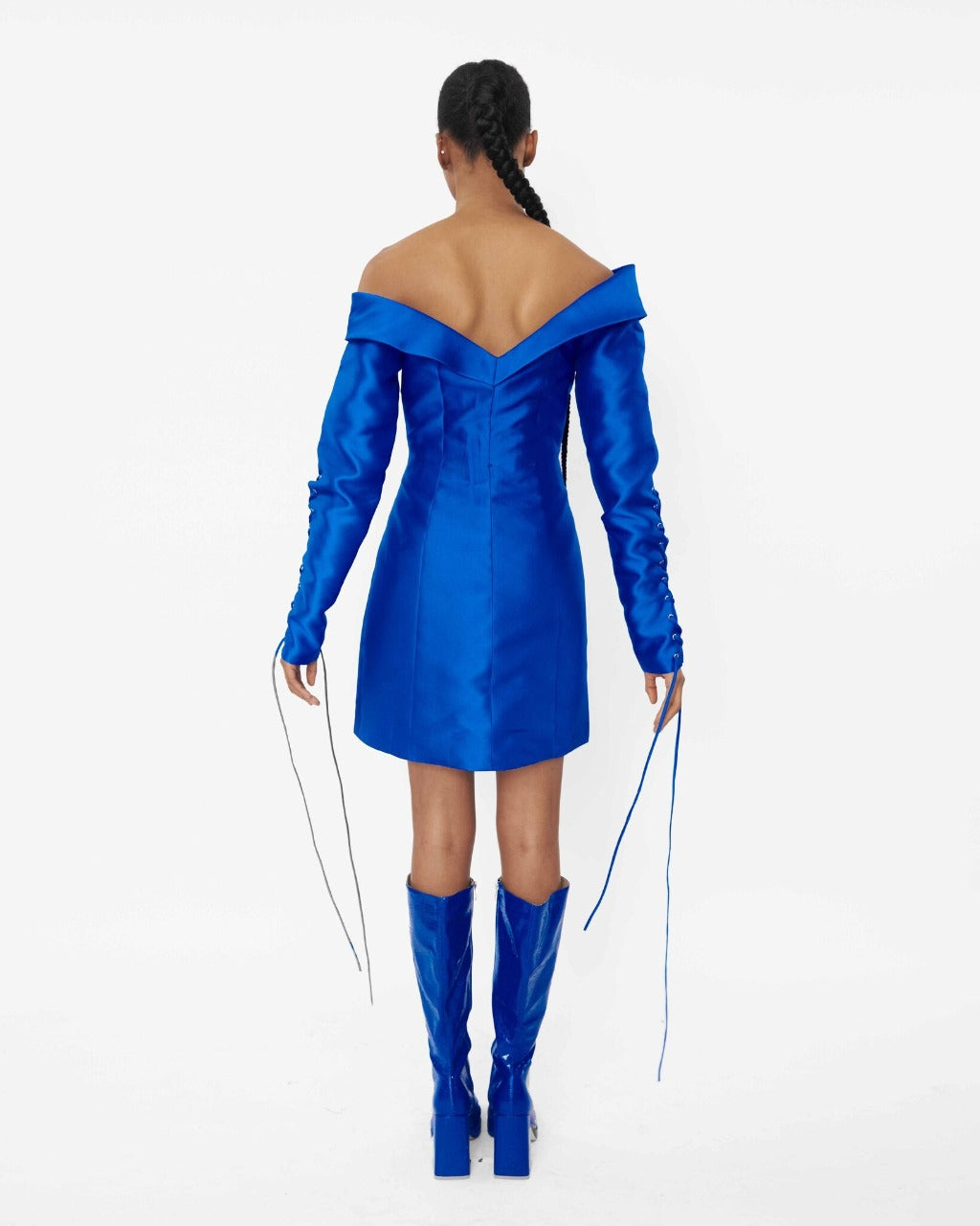 The back of a model wearing a Blue structured asymmetric neckline jacket dress with a lacing sleeve detail 