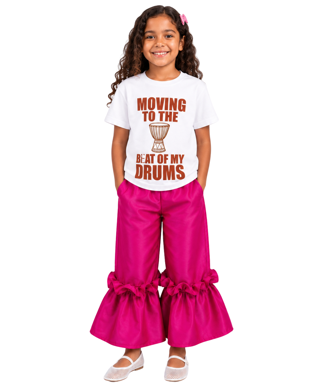 Young girl wearing the Bàtá graphic tee paired with Ruby ruffle pants from Imad Eduso Kids.