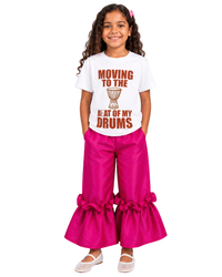 Young girl wearing the Bàtá graphic tee paired with Ruby ruffle pants from Imad Eduso Kids.