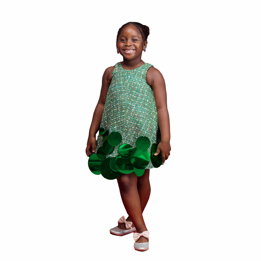 A kid model wearing a Green dress with sequins embellishment 