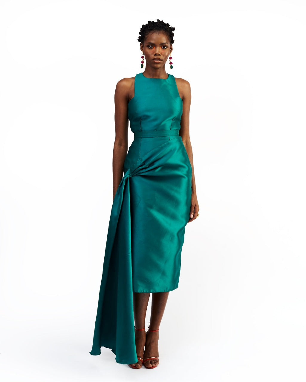A model wearing a green silk satin top and skirt