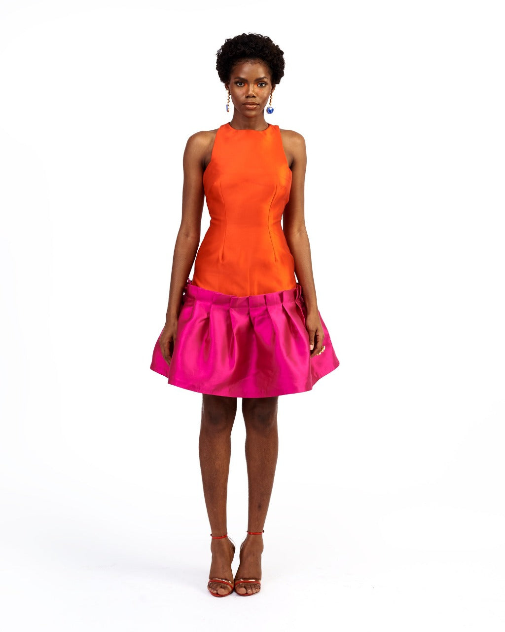 A model wearing an orange and magenta silk satin dress
