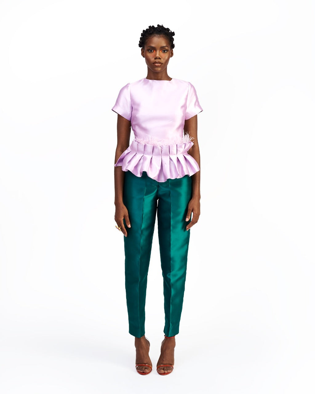 A model wearing green silk satin pants with a purple satin top