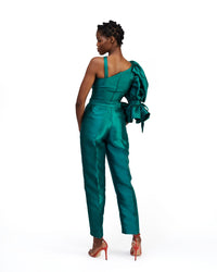 The back of a model wearing a silk satin green top and pants