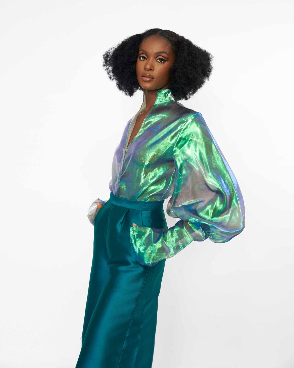 A model wearing an Iridescent Green top and a Green pant with sequins embellished