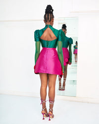 A model wearing a green Abeke top and a Magenta Abeke skirt embellished with sequins