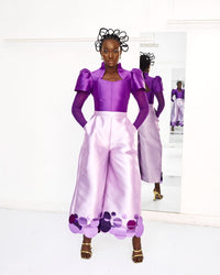 A model wearing a Lilac top and a Lilac pants with sequins embellishment in a white room