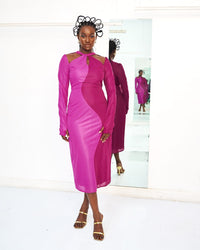 A model wearing a Fuchsia and Pink dress in a white room