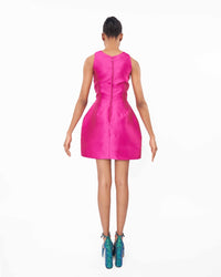 The back of a model wearing a magenta dress with ostrich feathers
