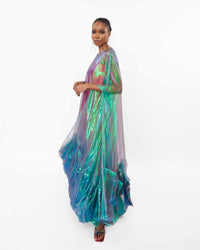 The side of a model wearing an Iridescent Green tea length dress with ruffles and silk slip lining