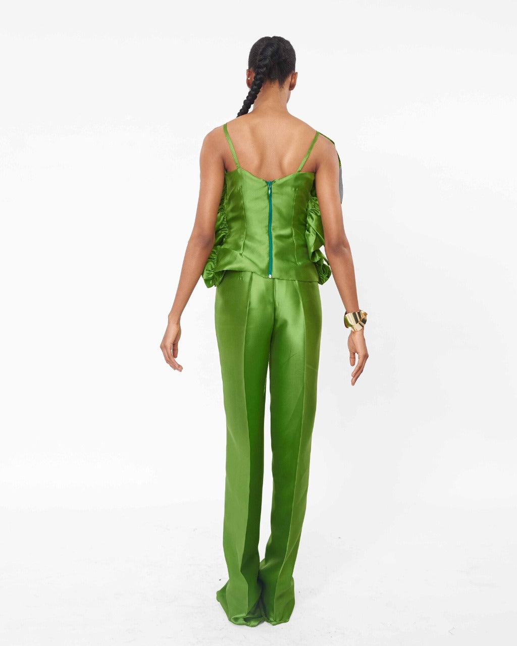 The back of a model wearing an Olive top with ruffle detail and an Olive high waist straight cut pant