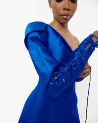 Close-uå odel wearing a Blue structured asymmetric neckline jacket dress with a lacing sleeve detail 