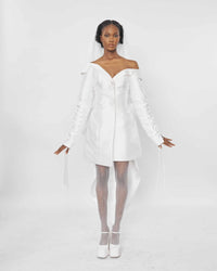 A model wearing a White structured asymmetric neckline jacket dress with a lacing sleeve detail 