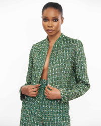 A model wearing a Green long sleeve jacket and a Green straight cut pant