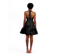 The back of a model wearing an black silk satin dress