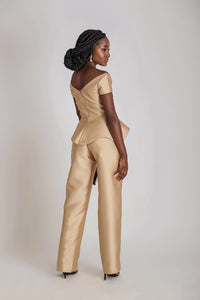 The back of a model wearing a one-shoulder brown Top and a brown high waist straight cut pant