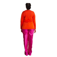 The back of A model wearing an Orange Top and a Magenta straight-cut pant