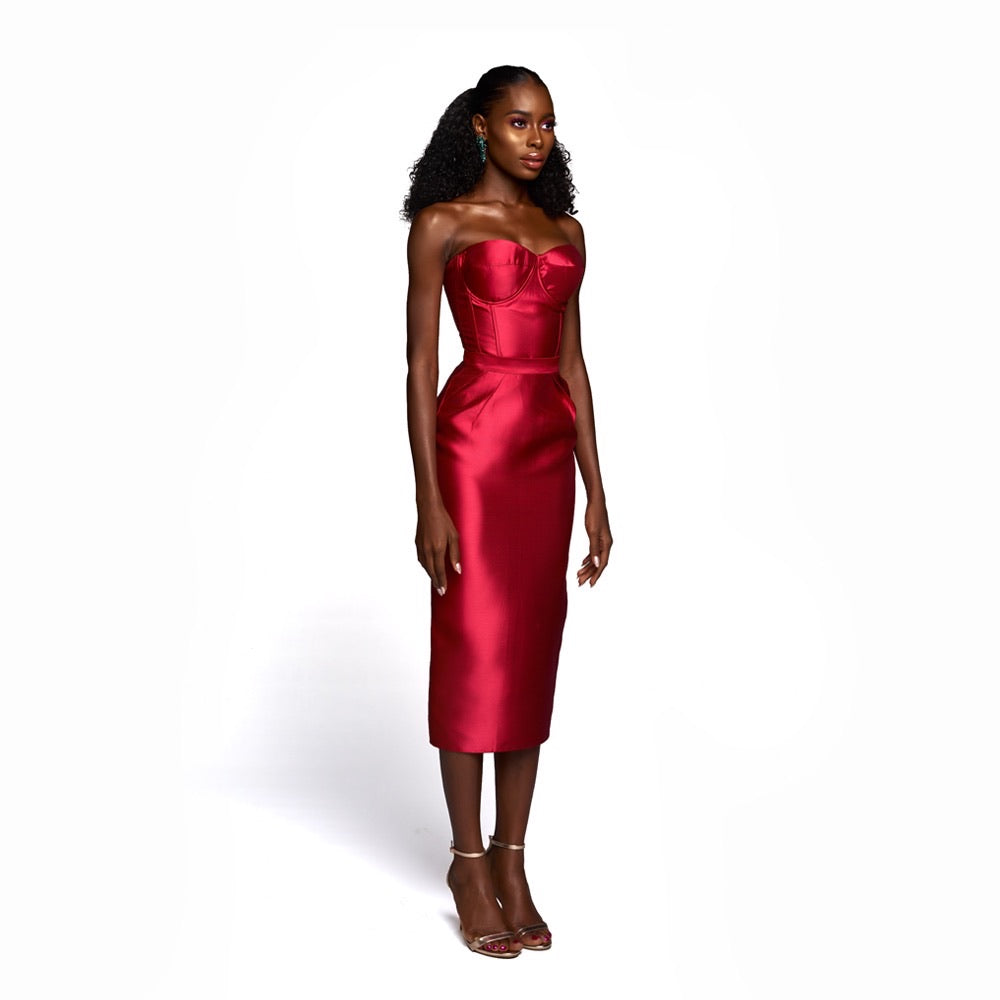 A model wearing a silk satin red top and skirt