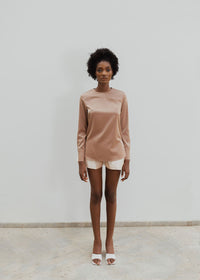 a model wearing a brown shirt and Nude colored shorts